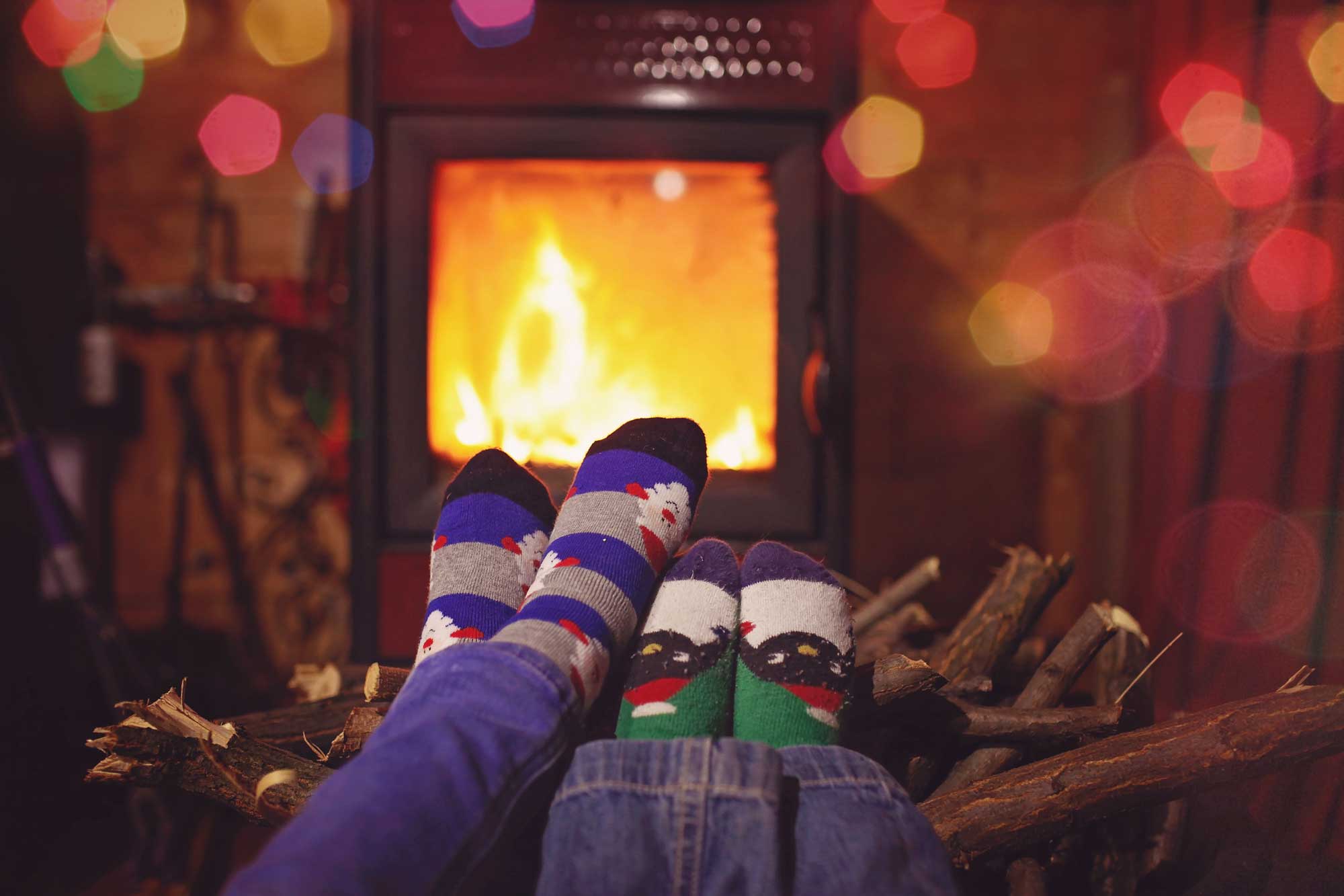 Mother and son feet by a fire